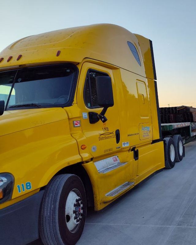Yellow LMB Freightliner Cascadia sleeper at sunrise